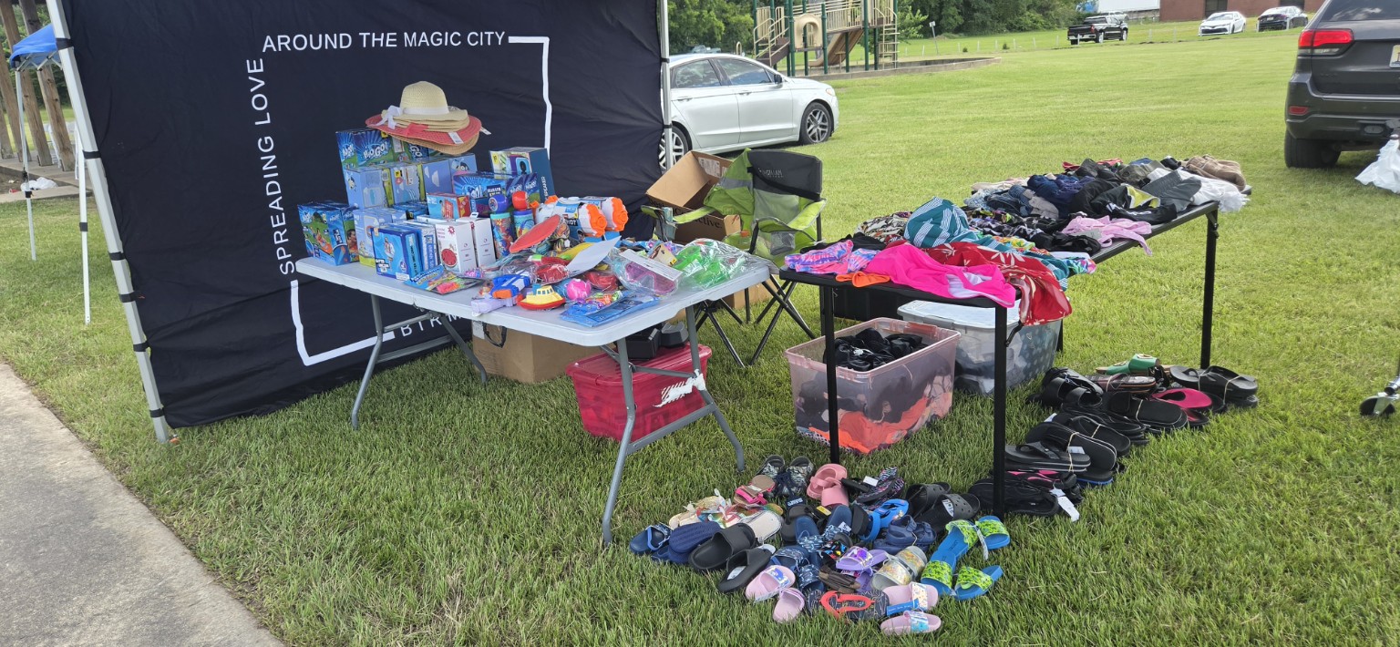 Be Kind Birmingham outdoor pop-up with branded backdrop, clothing, shoes and summer essentials