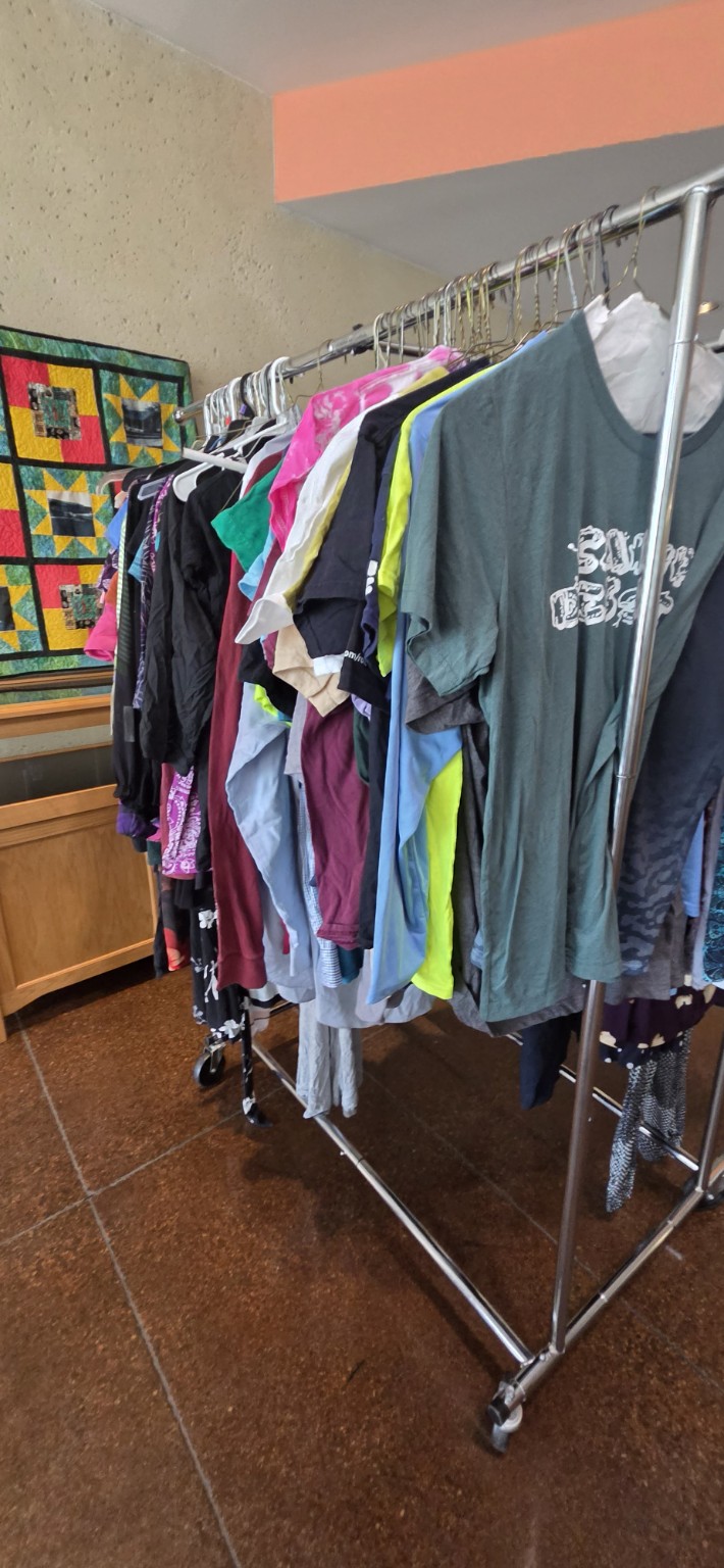 A full clothing rack available for participants to browse at a library pop-up